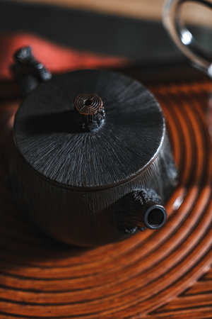 An Elegant and Stylish Black Teapot Placed on a Beautiful Traditional Tea Tray for Servingの写真素材