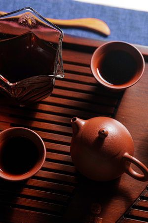 An Elegant Tea Set Displayed on a Wooden Tray Featuring a Traditional Teapot and Matching Cupsの写真素材