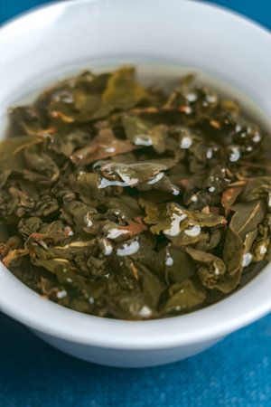 Fresh Green Herbal Tea in an elegant White Bowl, ideal for relaxation and mindfulnessの写真素材