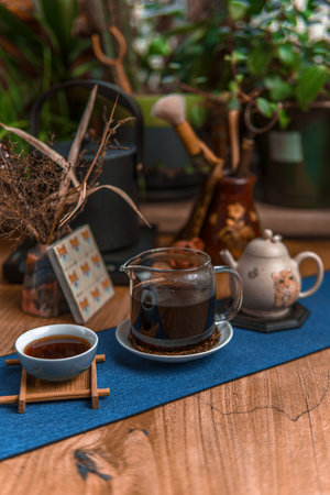 A Cozy and Inviting Coffee Setup with Beautiful Plants and Vintage Teapots Includedの写真素材