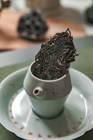 Enjoying Artisan Tea Leaves Presented in an Elegant Teapot for a Truly Serene Experience