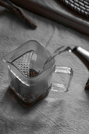 Pouring water slowly into a glass measuring jug creates a soothing and tranquil scene