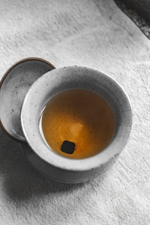 Enjoy a traditional tea ceremony with a crafted ceramic cup, inviting tranquility and culture