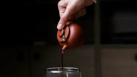 Pouring tea from a traditional teapot blends artistry and authenticity in a classic ritual