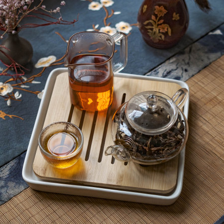 An Elegant Tea Setup with a beautiful Glass Teapot and charming Cups for a lovely experienceの写真素材