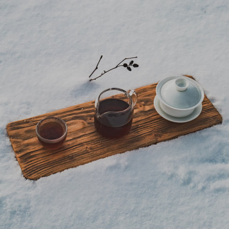 Indulging in the Warm Tea Experience while surrounded by a beautiful snowy landscapeの写真素材