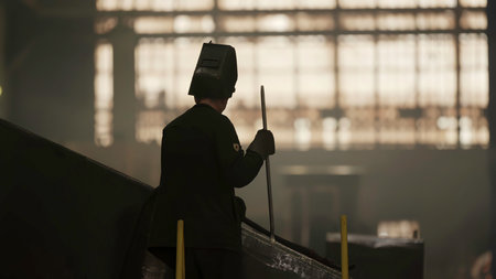 A Mysterious Figure Stands Amid an Industrial Setting as Dusk Begins to Fall All Around. Stock Clipの写真素材