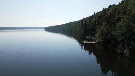 A Serene and Beautiful Lake Nestled Amidst a Breathtaking Lush Green Forested Area. Clipの写真素材