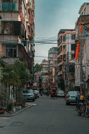 A vibrant urban street scene showcasing modern architecture accompanied by various vehiclesの写真素材