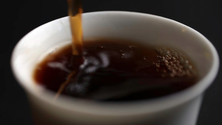 Pouring a steaming hot beverage into a delicate white cup enhances the overall experience. Media