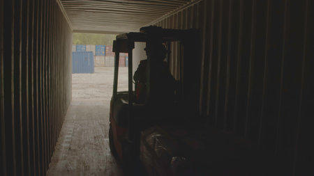 A forklift transports goods through a wide warehouse passageway, enhancing efficiency. Stock Footageの写真素材