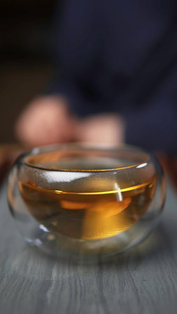 Aesthetic Close Up of Delightfully Golden Tea Poured into a Beautiful Glass Bowl. Media
