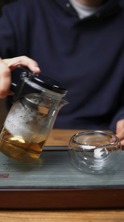 Brewing tea in a beautiful glass teapot while utilizing fresh herbs is a delightful experience. Mediaの写真素材
