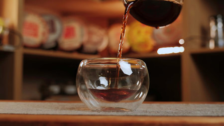 A person pours coffee, tea, and wine, showcasing beverage art. Mediaの写真素材