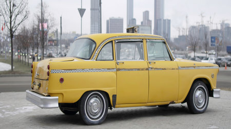 Classic yellow checker cab rotating on display. Actionの写真素材