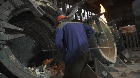 A worker is currently present inside an industrial facility where they are handling equipment. Stock...