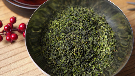 A Beautiful Bowl Filled with Dried Green Tea Surrounded by Natural Decor Elements. Mediaの写真素材