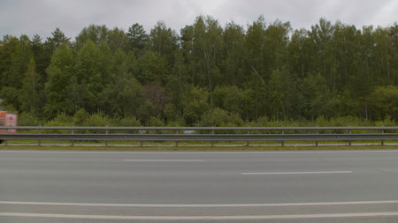 A Serene Highway Landscape Set Against a Lush Forest Backdrop Featuring Natures Beauty. Stock Footageの写真素材