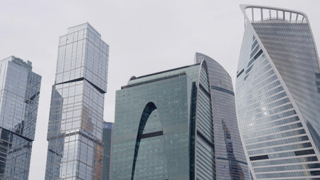 Modern skyscrapers stand tall against a cloudy sky, symbolizing economic activity and innovation. Actionの写真素材