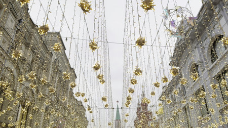 Sparkling golden decorations adorning nikolskaya street in Moscow for new year. Actionの写真素材