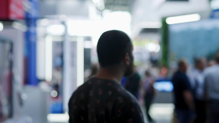Visitors walking in a blurred convention center corridor.の写真素材