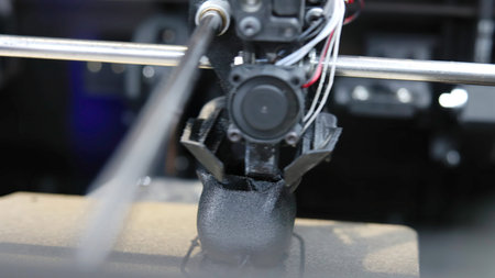 3d printer creating black plastic detailed object. Media