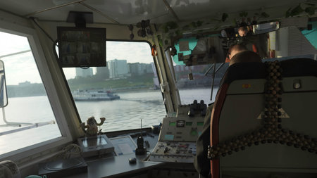 Ship captain navigating vessel on river from wheelhouse bridge. Clip
