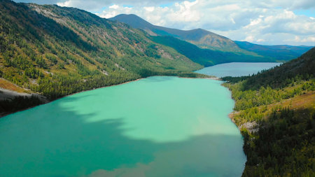 Aerial view flying over turquoise mountain lake.の写真素材
