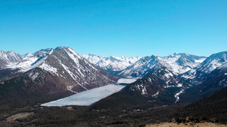 Majestic frozen lake nestled in snow capped mountains.の写真素材