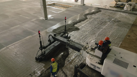 Laser screed machine pouring and leveling concrete floor. Clip
