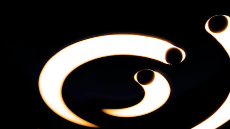 Flowing golden light trails forming abstract spiral designの写真素材