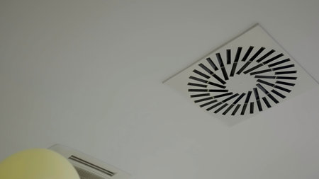 Balloons floating near air conditioning ceiling vents. Creative