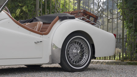 White triumph tr3 car parked in front of a gate. Action