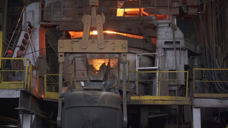 Industrial metallurgy: pouring molten metal in a foundry. Stock clip