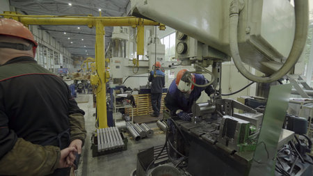Metal industry workers operating a hydraulic press in a factory. Stock clipの写真素材