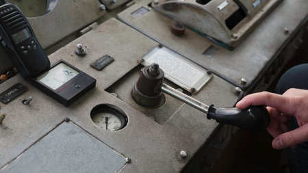 Engineer operating lever on control panel. Clipの写真素材