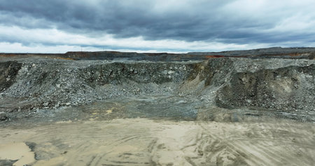 Mining excavator loading ore into a dump truck in open pit mine. Stock clipの写真素材