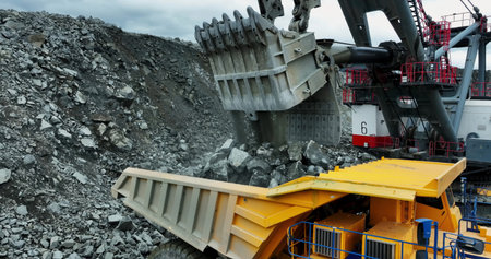 Giant excavator loading ore into mining truck. Stock clip