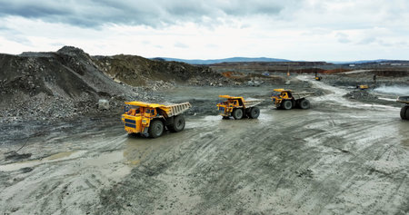 Mining trucks transporting minerals in open pit mine. Stock clipの写真素材
