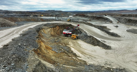 Excavator loading dump truck in open pit mine. Stock clip