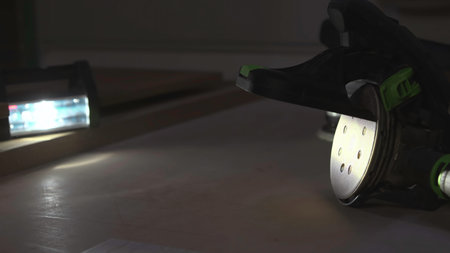 Careful Restoration With Sander Disc Mobile Over Wood Surface Illuminated By Intense Inspection...