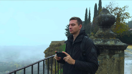 Traveler Photographs Misty Scenery Retrospectively, Explorer Documents Gloomy Valley With Camera...