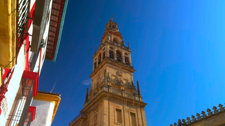 Bright Tower View, Vivid Perspective Of Historic Bell Tower With Decorative Elements Under Clear Blue Skyの写真素材
