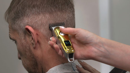 Closeup Of Barber Shaping Hair Carefully, Young Man Receiving Precise Grooming In Warm Salon Setting