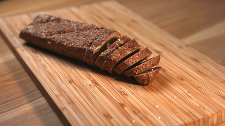 Sliced rye bread on a wooden cutting board.