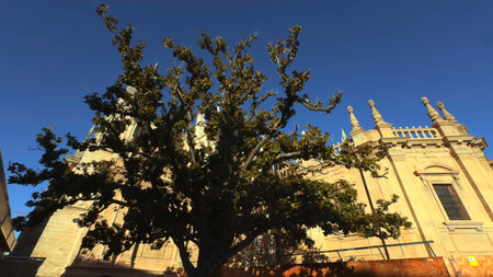 Sunlight Bathes Old Cathedral Exterior, Urban Scene Capturing Architectural Beauty And Vibrant Ambiance . Actionの写真素材