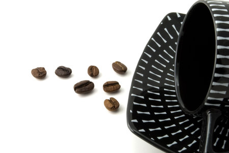 Black cup for coffee and grain on a white background