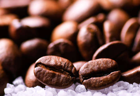 Grains of black coffee on sugar granulesの写真素材