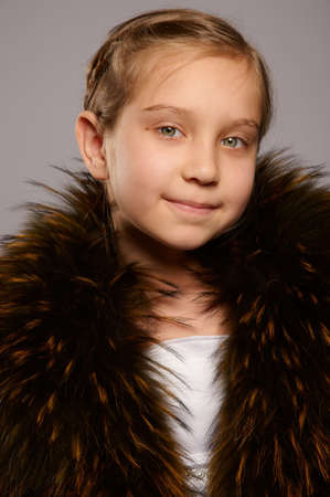 Smiling girl blonde in fur coatの写真素材