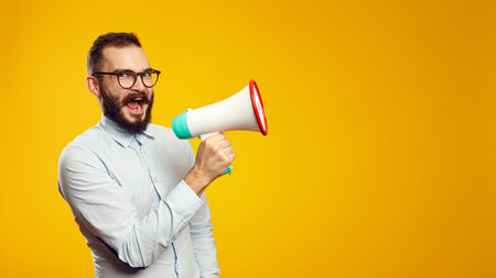 Horizontal photo of a handsome man wearing blue shirt and eyeglasses standing isolated over yellow...